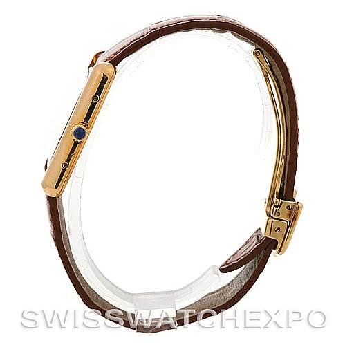 The image shows a side view of the Cartier Tank Louis Yellow Gold Beige Dial Yellow Gold Beige Dial watch, highlighting its brown leather strap and gold case.