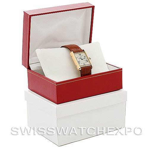 The image shows a Cartier Tank Louis Yellow Gold Beige Dial Yellow Gold Beige Dial watch with a brown strap, displayed at an angle in an open red box on top of a white box.