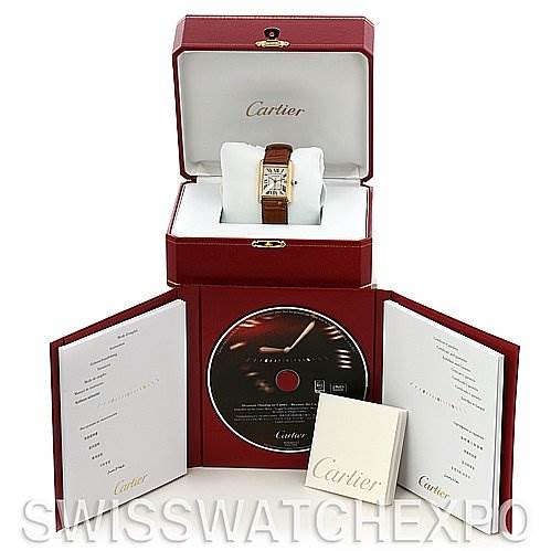 The image shows a Cartier Tank Louis W1529756 Yellow Gold White Dial W1529756 Yellow Gold White Dial watch displayed in its open box, with accompanying manuals and a CD.