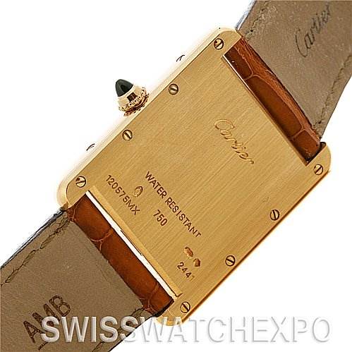 The image shows the case back of a Cartier Tank Louis W1529756 Yellow Gold White Dial W1529756 Yellow Gold White Dial watch, featuring engraved details and a brown leather strap.