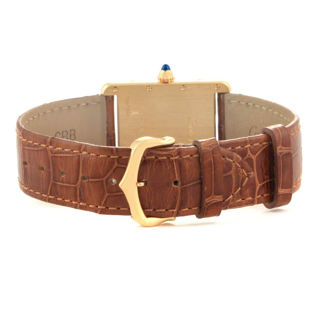 This image shows the back view of a Cartier Tank Louis W1529756 Men's Yellow Gold Silver Dial W1529756 Men's Yellow Gold Silver Dial watch, focusing on the golden buckle and brown leather strap.