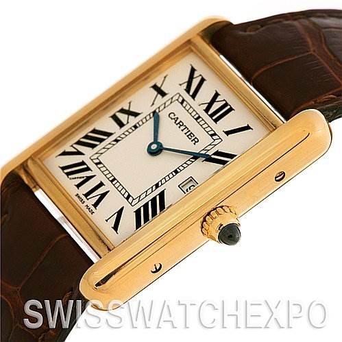 The image shows a Tank Louis model by Cartier at an angle highlighting the dial, crown, case, and part of the leather strap.
