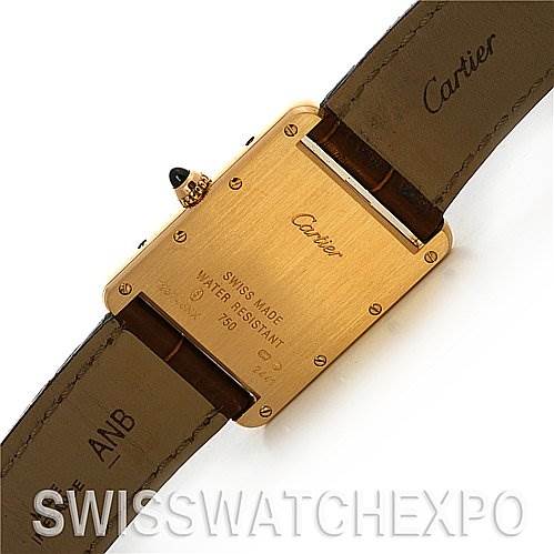 The image shows the back of the Tank Louis model by Cartier, highlighting the case back and leather straps.
