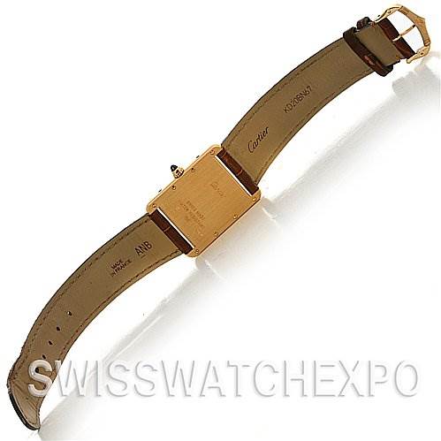 The image shows the back and strap of a Tank Louis model watch by Cartier, emphasizing the case back and leather strap.