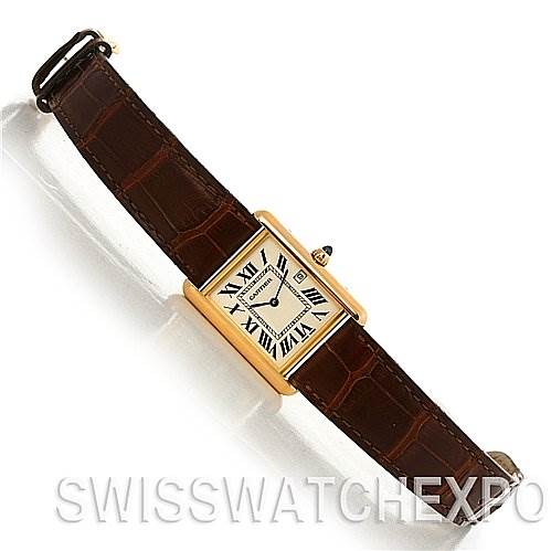 This image shows an overhead view of the Cartier Tank Louis W1529756 Yellow Gold White Dial W1529756 Yellow Gold White Dial watch, showcasing its rectangular dial and leather strap.