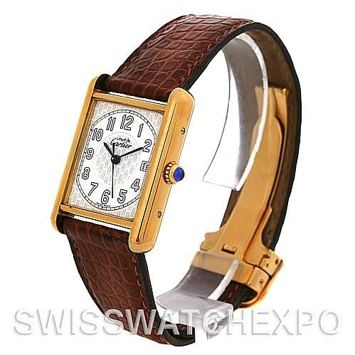 The image shows a side angle of a Cartier Tank Louis Yellow Gold White Dial Yellow Gold White Dial watch, highlighting the brown leather strap, gold case, and white dial with Arabic numerals.