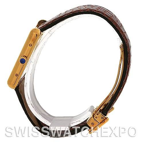 The image shows a side profile of a Cartier Tank Louis Yellow Gold White Dial Yellow Gold White Dial watch, highlighting its crown and leather strap.