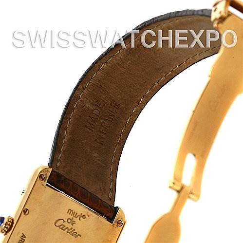 The image shows the inner side of the leather strap and case back of a Tank Louis model watch by Cartier.