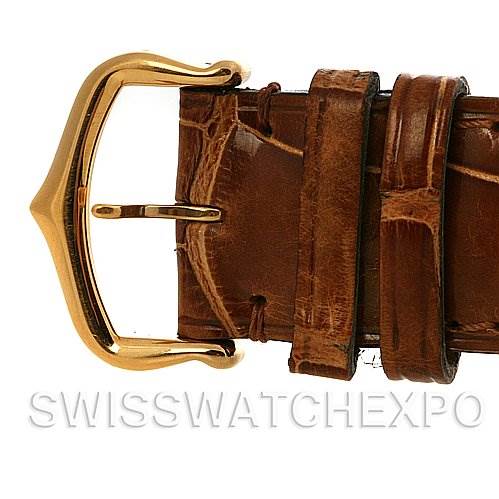 The image shows a close-up of the brown leather strap and gold buckle of a Tank Louis Cartier watch.