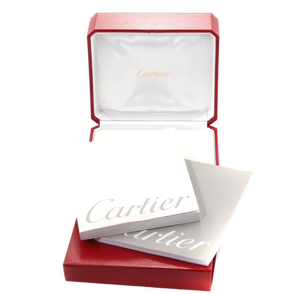 The image shows an open Cartier watch box for the Tank Louis model with accompanying booklets.
