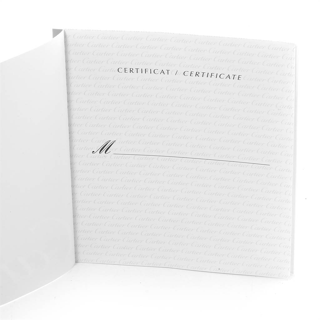 This image depicts a partially opened certificate booklet for the Tank Louis model by Cartier.