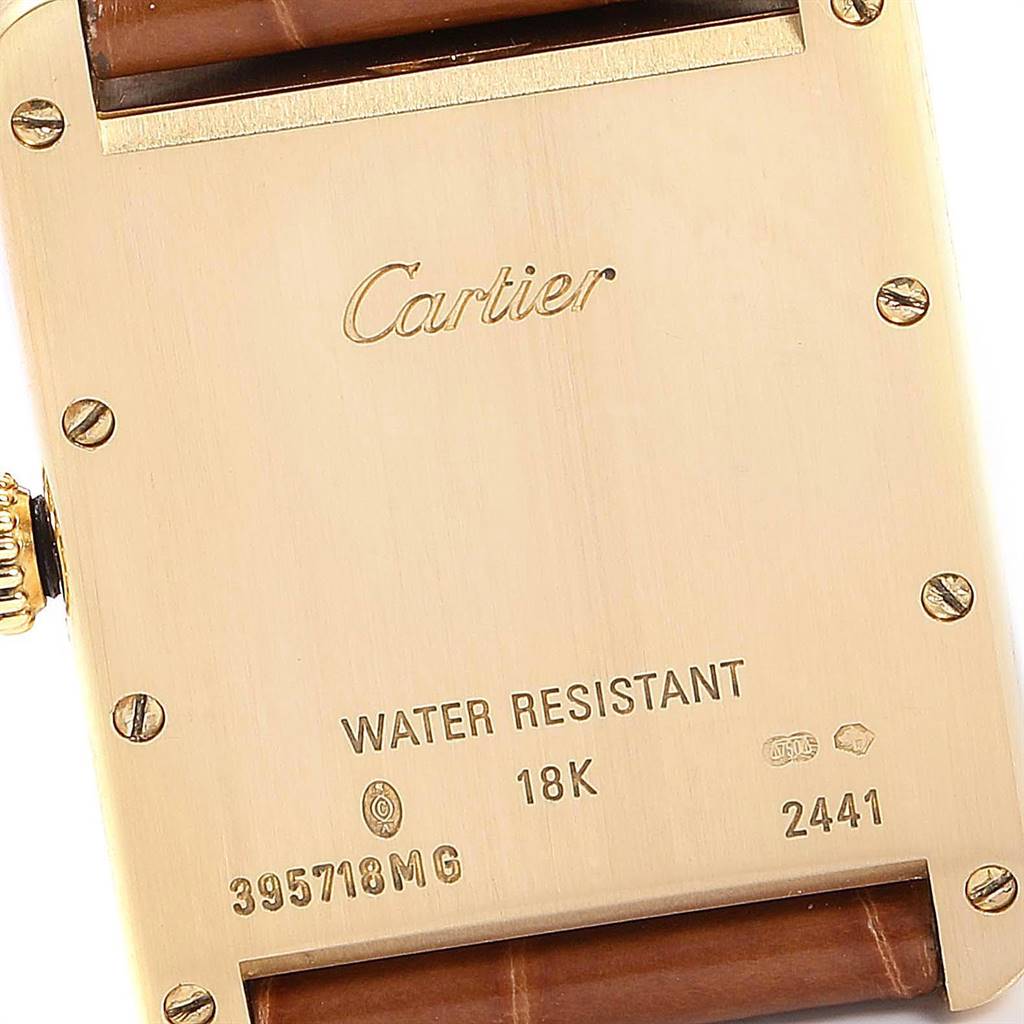 This image shows the back casing of the Tank Louis model watch by Cartier, highlighting the water resistance and 18k gold markings.
