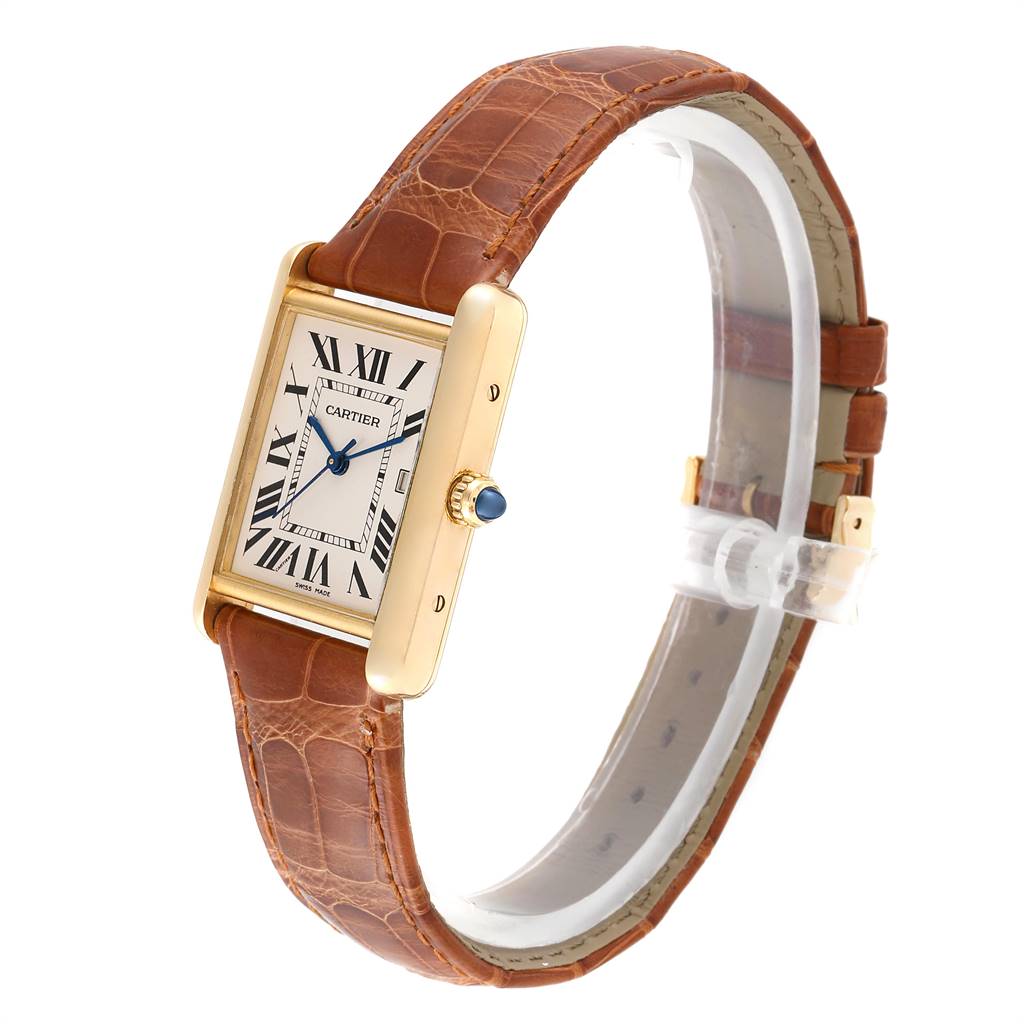 The image shows a Tank Louis model by Cartier from a three-quarter angle, highlighting the dial, leather strap, and crown.