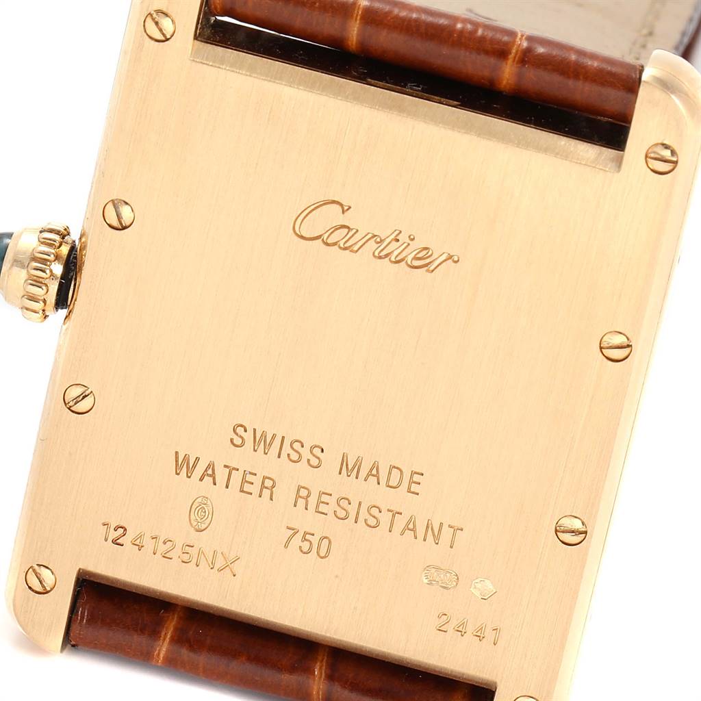The image shows the back case of the Cartier Tank Louis W1529756 Men
s Yellow Gold Silver Dial W1529756 Men
s Yellow Gold Silver Dial watch, displaying engravings and part of the leather strap.