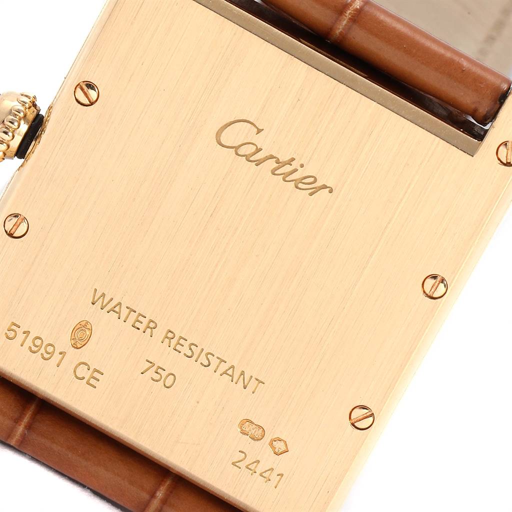 The image shows the back casing and part of the strap of a Cartier Tank Louis W1529756 Men
s Yellow Gold Silver Dial W1529756 Men
s Yellow Gold Silver Dial watch.