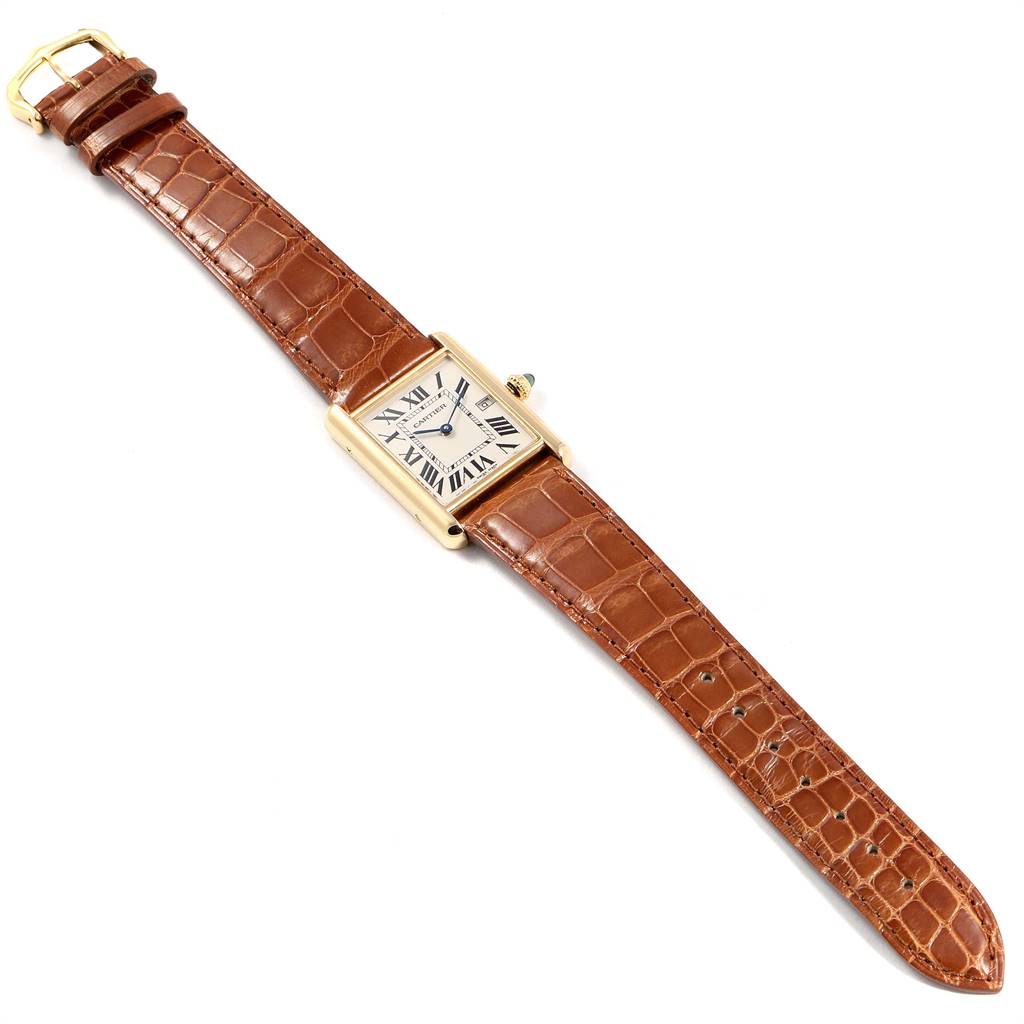 This is a top-down view of a Cartier Tank Louis W1529756 Men
s Yellow Gold Silver Dial W1529756 Men
s Yellow Gold Silver Dial watch, showing the face, brown leather strap, and gold buckle.