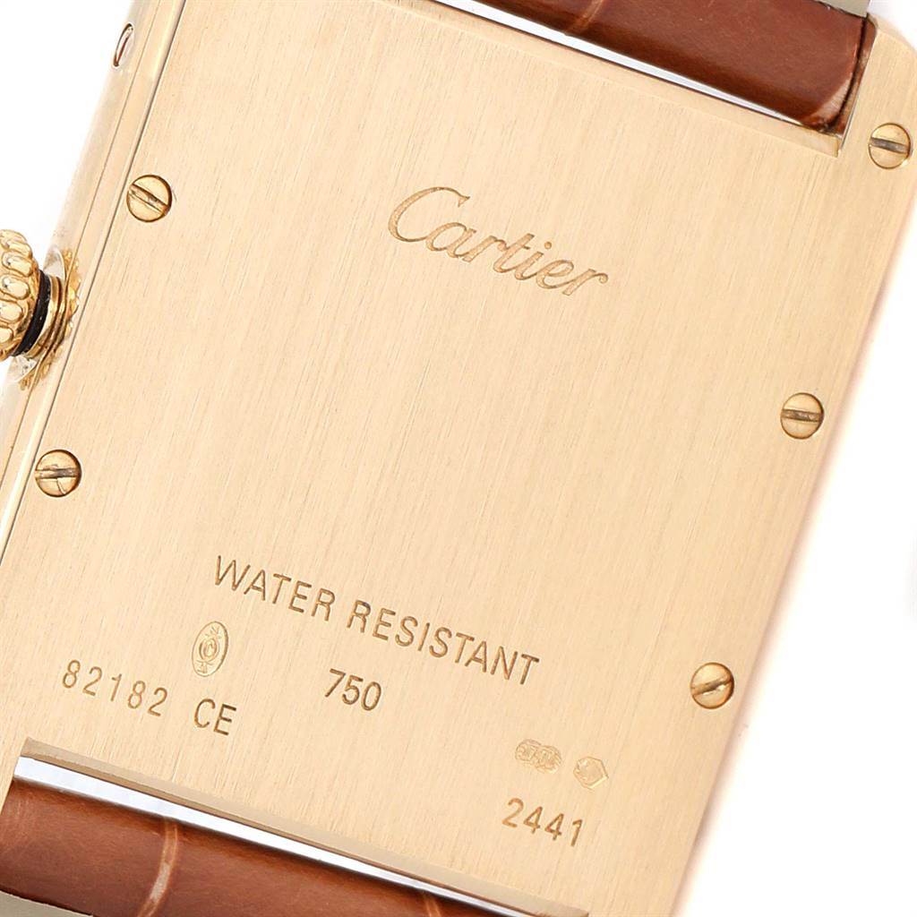 The image shows the back of a Cartier Tank Louis W1529756 Men
s Yellow Gold Silver Dial W1529756 Men
s Yellow Gold Silver Dial watch, including part of the leather strap and the crown.