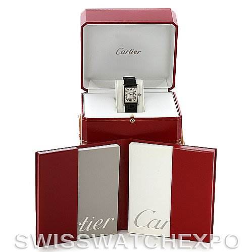 This image shows a Cartier Tank Louis W1540956 White Gold White Dial W1540956 White Gold White Dial watch resting in an open Cartier box with manuals/books placed around it.