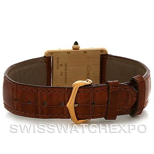 The image shows the back view of a Cartier Tank Louis W1529756 Yellow Gold White Dial W1529756 Yellow Gold White Dial watch with a brown leather strap and gold buckle.