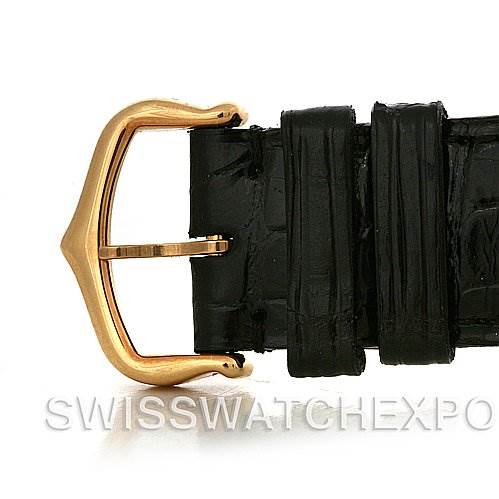 This image shows a close-up of the buckle and black leather strap of a Tank Louis model by Cartier.