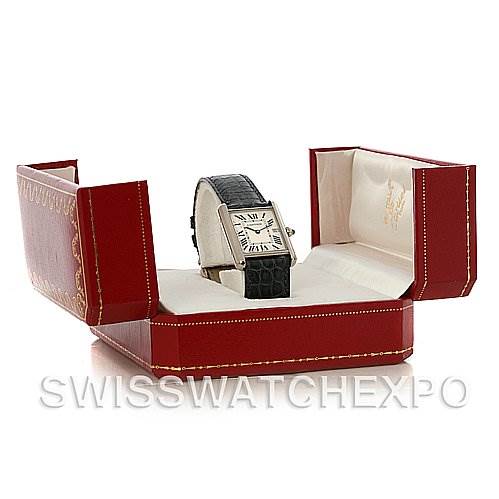 The Tank Louis model by Cartier is showcased at an angle in an open red box, displaying its face and black leather strap.