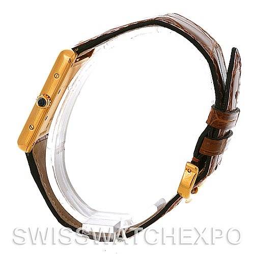 The image shows a Tank Louis model by Cartier, viewed from the side, highlighting the watch case, crown, and leather strap.