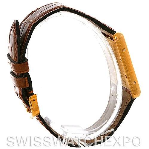 The image shows a side angle of a Cartier Tank Louis W1529756 Men
s Yellow Gold Silver Dial W1529756 Men
s Yellow Gold Silver Dial watch highlighting the gold case and brown leather strap.