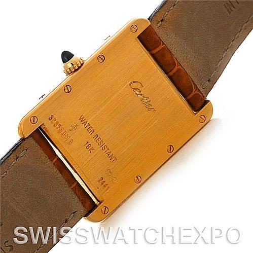 The image shows the back case and part of the strap of a Cartier Tank Louis W1529756 Men
s Yellow Gold Silver Dial W1529756 Men
s Yellow Gold Silver Dial watch at a slight angle.
