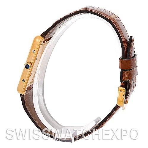 The image shows a side view of the Cartier Tank Louis W1529756 Men
s Yellow Gold Silver Dial W1529756 Men
s Yellow Gold Silver Dial watch, highlighting the gold case, sapphire cabochon crown, and brown leather strap.