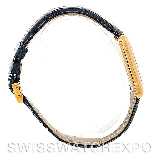 The image shows a side profile of the Cartier Tank Louis W1529756 Men
s Yellow Gold Silver Dial W1529756 Men
s Yellow Gold Silver Dial watch, highlighting its gold case and black leather strap.