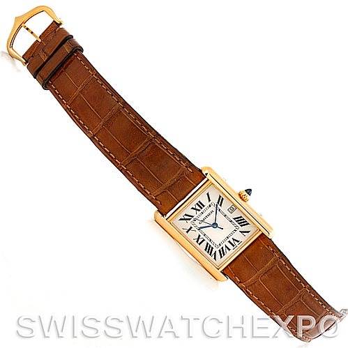 This image shows an overhead view of a Cartier Tank Louis W1529756 Men's Yellow Gold Silver Dial W1529756 Men's Yellow Gold Silver Dial watch featuring a brown leather strap and a rectangular gold case.