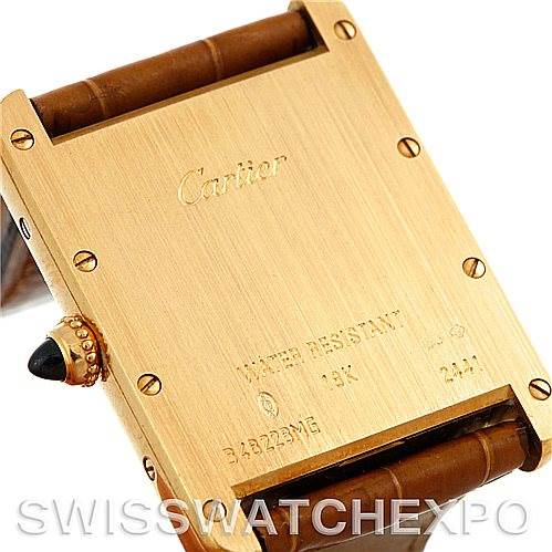 The image shows the back case of a Cartier Tank Louis W1529756 Men's Yellow Gold Silver Dial W1529756 Men's Yellow Gold Silver Dial watch, highlighting its inscriptions and leather strap attachments.