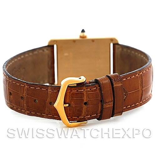 The image shows the back view of a Cartier Tank Louis W1529756 Men's Yellow Gold Silver Dial W1529756 Men's Yellow Gold Silver Dial watch with its brown leather strap and gold buckle.