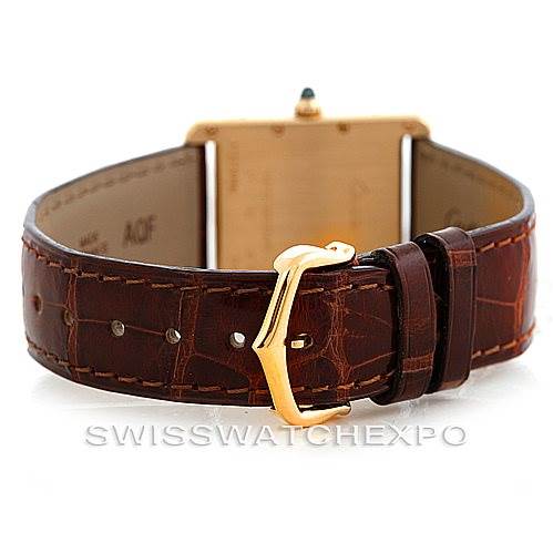 The image shows the back of a Cartier Tank Louis W1529756 Men's Yellow Gold Silver Dial W1529756 Men's Yellow Gold Silver Dial watch, highlighting its brown leather strap and gold buckle.