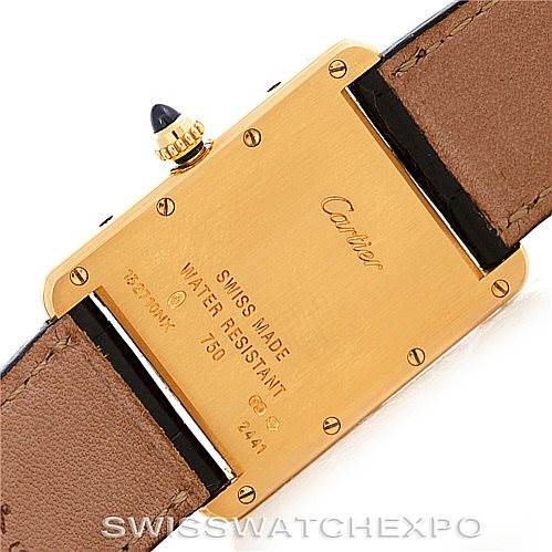 The image shows the back casing of a Cartier Tank Louis W1529756 Men's Yellow Gold Silver Dial W1529756 Men's Yellow Gold Silver Dial watch, along with the leather strap and manufacturer's inscriptions.