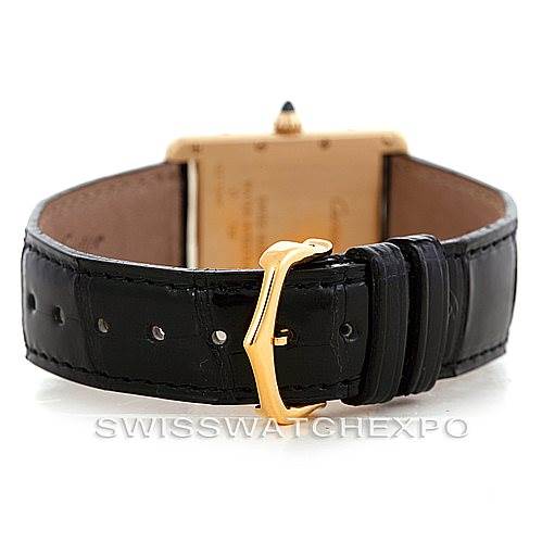 The image shows the Tank Louis model by Cartier from the back, highlighting the black leather strap and gold buckle.