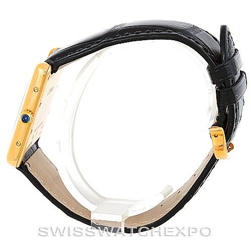 The image shows a side view of a Cartier Tank Louis W1529756 Men's Yellow Gold Silver Dial W1529756 Men's Yellow Gold Silver Dial watch, highlighting its gold case, black leather strap, and blue cabochon crown.