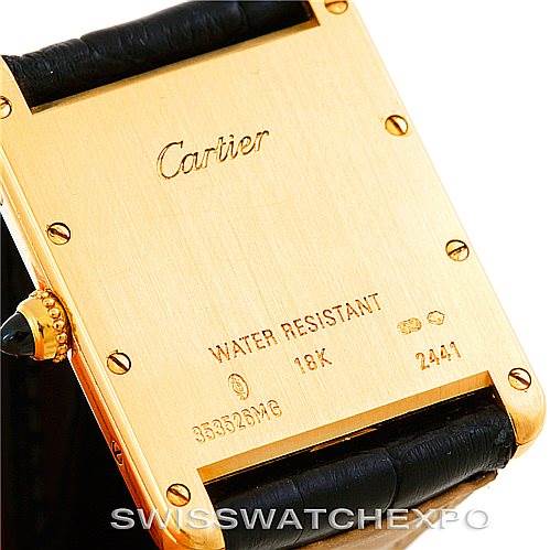 This image shows the back case of the Cartier Tank Louis W1529756 Men's Yellow Gold Silver Dial W1529756 Men's Yellow Gold Silver Dial watch, including the engravings and part of the leather strap.