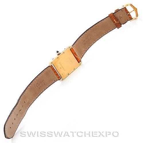 The image shows the back view of a Tank Louis model by Cartier, highlighting the case back and leather strap.