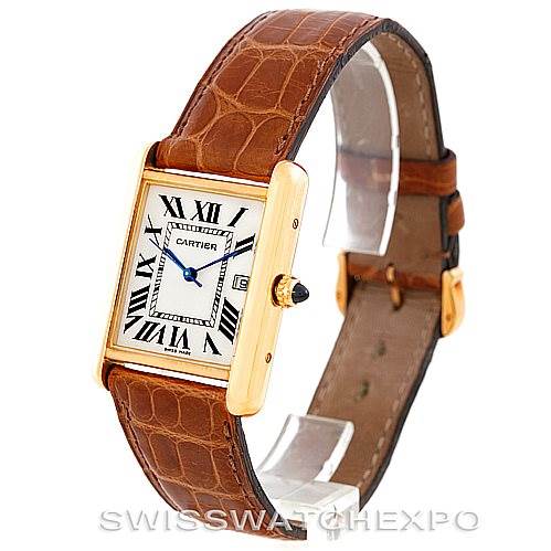 The image shows a Tank Louis model by Cartier at an angled view, highlighting the rectangular case, crown, leather strap, and Roman numeral dial.