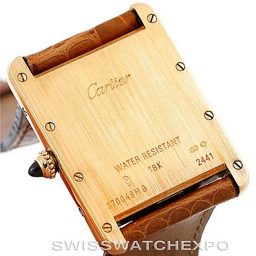 This image shows the back of a Cartier Tank Louis W1529756 Men's Yellow Gold Silver Dial W1529756 Men's Yellow Gold Silver Dial model watch, highlighting the case back and partial leather strap.