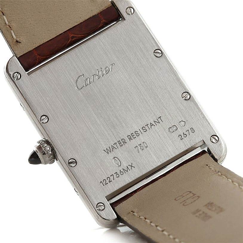 The image shows the back case and part of the strap of a Tank Louis watch by Cartier.