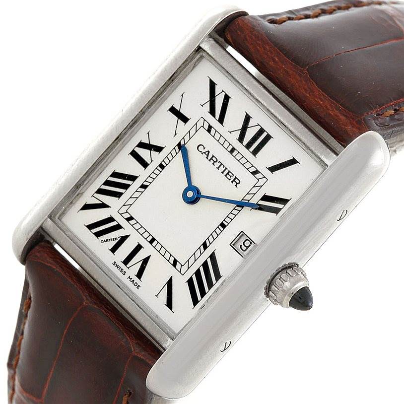 The image shows a Cartier Tank Louis W1540956 Men's White Gold White Dial W1540956 Men's White Gold White Dial watch at an oblique angle, highlighting its rectangular dial, Roman numerals, blue hands, crown, and leather strap.
