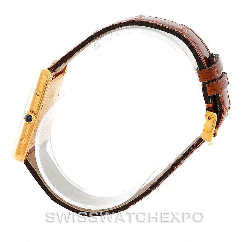 The image shows a side view of the Cartier Tank Louis W1529756 Men's Yellow Gold Silver Dial W1529756 Men's Yellow Gold Silver Dial watch, highlighting its gold case, crown, and brown leather strap.