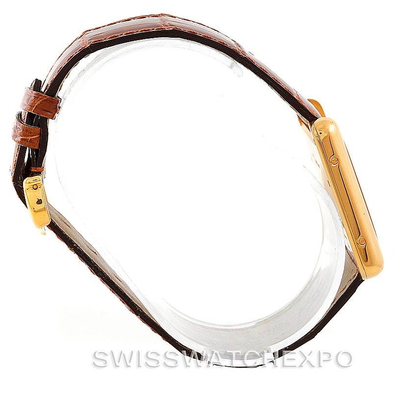 This image shows a side view of the Cartier Tank Louis W1529756 Men's Yellow Gold Silver Dial W1529756 Men's Yellow Gold Silver Dial watch, highlighting the gold case, buckle, and brown leather strap.