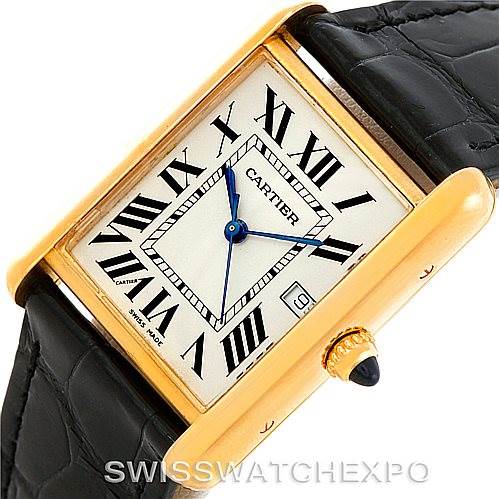 This image shows the face, crown, and part of the leather band of the Tank Louis model watch by Cartier from an angled top view.