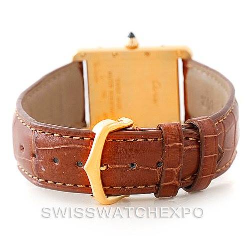 The image shows the backside of the Cartier Tank Louis W1529756 Men's Yellow Gold Silver Dial W1529756 Men's Yellow Gold Silver Dial model watch, highlighting its brown leather strap and gold buckle.