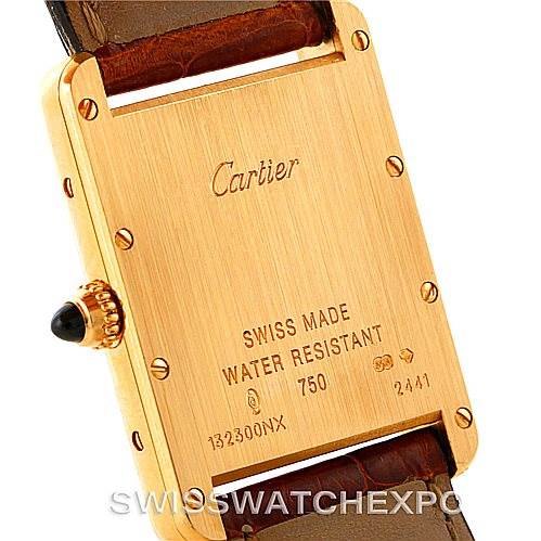 The image shows the case back and crown of a Cartier Tank Louis W1529756 Men's Yellow Gold Silver Dial W1529756 Men's Yellow Gold Silver Dial watch, highlighting engravings and the leather strap.
