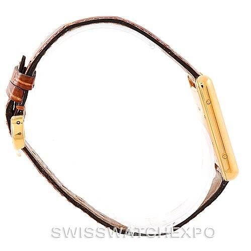 The image shows a side view of a Cartier Tank Louis W1529756 Men's Yellow Gold Silver Dial W1529756 Men's Yellow Gold Silver Dial model watch, highlighting its slim profile and leather strap.