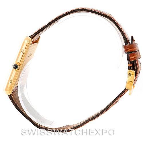 This image shows a side view of the Cartier Tank Louis W1529756 Men's Yellow Gold Silver Dial W1529756 Men's Yellow Gold Silver Dial watch, highlighting the gold case, crown with a blue cabochon, and brown leather strap.